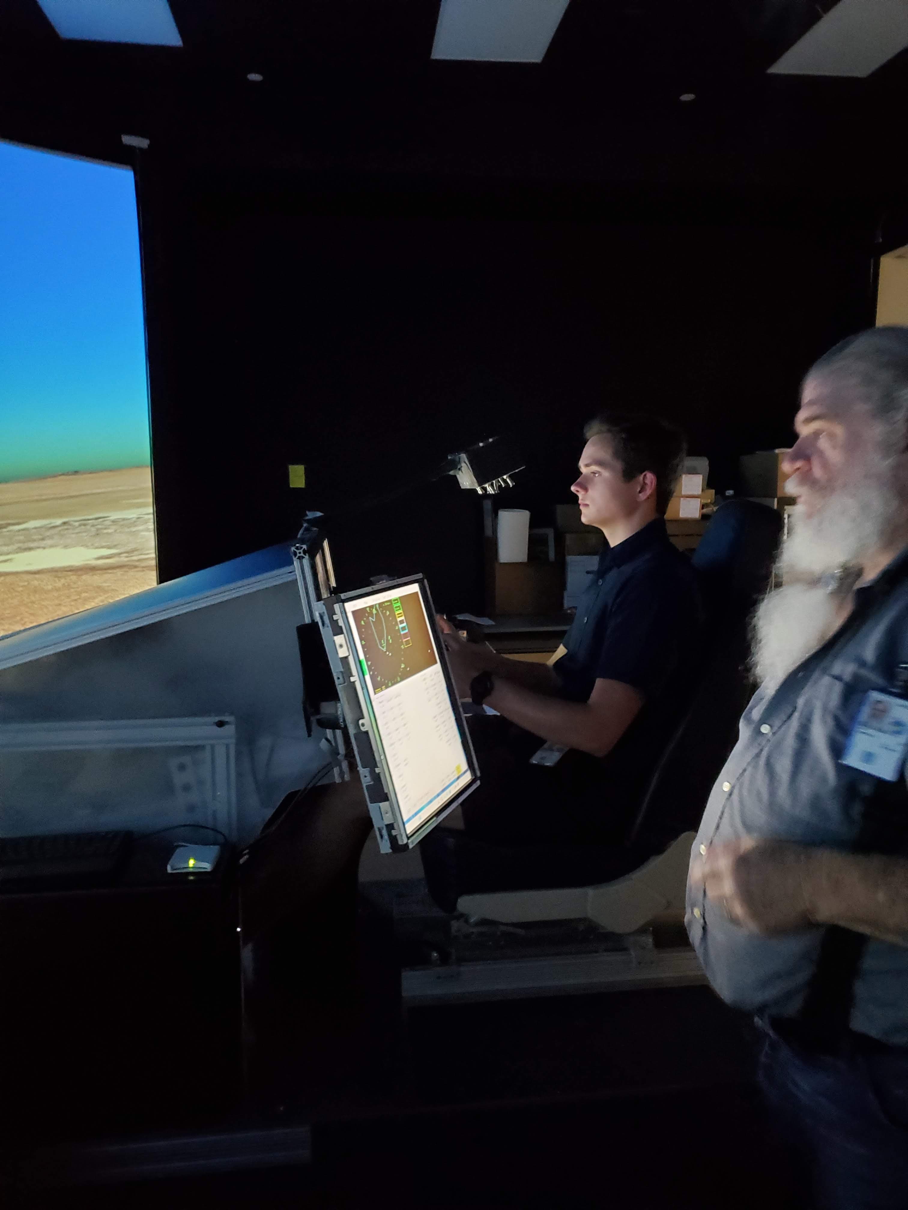 Seated at a NASA flight simulator