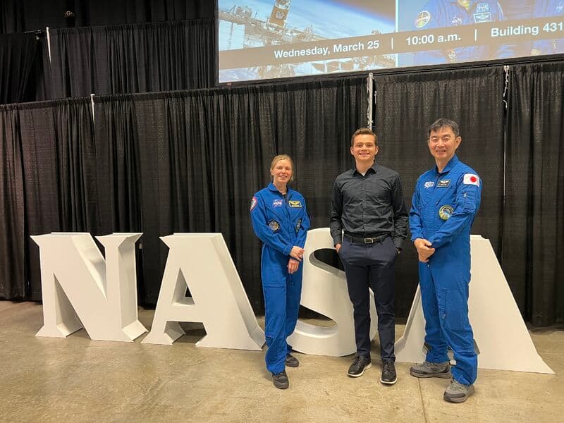 Standing with two Crew-11 astronauts at a NASA event